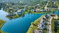 Large pond with rich expensive homes in neighborhood aerial