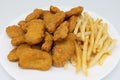 Chicken Nuggets and French Fries on a White Plate with a White Background Royalty Free Stock Photo