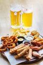 Large portion of snacks and 2 glasses of light beer Royalty Free Stock Photo