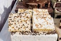 Large portions of home made Nougat confectionary made with sugar or honey, almonds and dried fruits, displayed for sale at a tradi