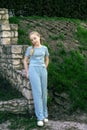 Large portrait of a beautiful blonde girl with braids standing against a brick wall. girl 13-15 years old Royalty Free Stock Photo