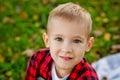 A large portrait of a boy in nature, in the park or outdoors. A child on a green background