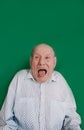 a large portrait of a crazy old man on an isolated green background. chromakey