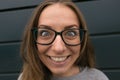 Large portrait of a girl with glasses on a gray background