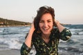 Large portrait of a young woman on the beach at red sunset, selfie, smile, fun, vacation