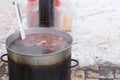 Large pot of mulled wine on a potbelly stove