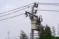 A large power transformer is mounted on a high voltage pole with wires connected to the transformer Royalty Free Stock Photo