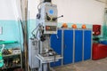 A large powerful iron metal bench-type screw-cutting lathe for the manufacture of parts and spare parts with handles and buttons,