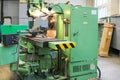 A large powerful iron metal bench-type screw-cutting lathe for the manufacture of parts and spare parts with handles and buttons,