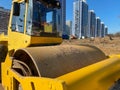 Large powerful modern yellow roller for asphalt paving, repair and road construction. New construction machinery and equipment at Royalty Free Stock Photo