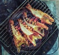 Large prawns are placed on an iron griddle and grilled over a hot coal stove Royalty Free Stock Photo