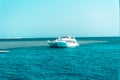 A large private motor yacht under way sailing out on tropical sea. Royalty Free Stock Photo