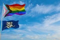 large progress lgbtq flag and flag of Connecticut state, USA waving in the wind at cloudy sky. Freedom and love concept. Pride