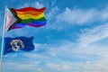 large progress lgbtq flag and flag of the Northern Mariana Islands state, USA waving in wind at cloudy sky. Freedom and love