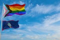 large progress lgbtq flag and flag of Guam state, USA waving in the wind at cloudy sky. Freedom and love concept. Pride month.