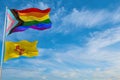 large progress lgbtq flag and flag of New Mexico state, USA waving in the wind at cloudy sky. Freedom and love concept. Pride