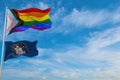 large progress lgbtq flag and flag of Utah state, USA waving in the wind at cloudy sky. Freedom and love concept. Pride month.