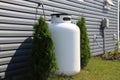 A large propane tank on the side of a house Royalty Free Stock Photo