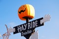 A large pumpkin head invites visitors to go on a hayride or train