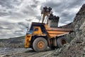 Large quarry dump truck. Loading the rock in the dumper. Loading Royalty Free Stock Photo