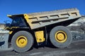 Large quarry dump truck. Loading the rock in the dumper. Loading Royalty Free Stock Photo