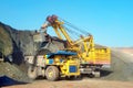 Large quarry dump truck. Loading the rock in the dumper. Loading coal into body work truck Royalty Free Stock Photo