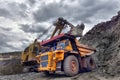 Large quarry dump truck. Loading the rock in the dumper. Loading Royalty Free Stock Photo