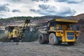 Large quarry dump truck. Loading the rock in the dumper. Loading Royalty Free Stock Photo