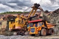 Large quarry dump truck. Loading the rock in the dumper. Loading Royalty Free Stock Photo