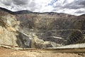 Large quarry site. Big yellow mining truck at work site. Loading sand into body truck. Production useful minerals. Mining truck Royalty Free Stock Photo