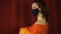 Large rainbow flag slips off young naked woman in black protective mask Royalty Free Stock Photo