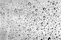 Large raindrops on a window glass in rainy cloudy day against a gray sky. Autumn, depressive, rainy weather. Selective focus Royalty Free Stock Photo