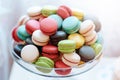 A large range of delicious and beautiful little macaroons in a glass vase. Gentle almond cookies of bright colors