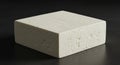 A large, rectangular block of tofu sits on a dark surface. The tofu is off-white with