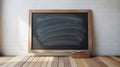 Empty wooden framed chalkboard with chalk erased marks hanging on a white brick wall above a wooden floor Royalty Free Stock Photo