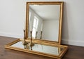 Mirror also has a matching gold frame. Two brass candlesticks Royalty Free Stock Photo