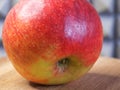 A large red apple on a wooden surface, a macro  shot Royalty Free Stock Photo