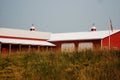 A large red barn in rural Wisconsin with wild grasses. Royalty Free Stock Photo