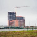 Large red brick building under construction. Construction crane at building under construction Royalty Free Stock Photo