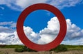 A large red circle sculpture, The Ring (Anello), by Mauro Staccioli by the Royalty Free Stock Photo