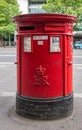 Large red cylindrical mail box on street, London, Great Britain Royalty Free Stock Photo
