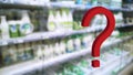 Large red 3d question mark on abstract blur supermarket background. Defocused shelves with food and dairy products. Grocery Store Royalty Free Stock Photo