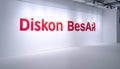 Large red Diskon BesAr logo on white wall in empty room with spotlights Royalty Free Stock Photo