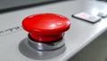 Large red emergency stop button on gray metal control panel with silver base Royalty Free Stock Photo