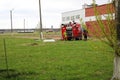 A large red fire rescue vehicle, a truck to extinguish a fire and male firefighters are prepared to work at a chemical, petroleum Royalty Free Stock Photo