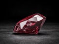 A large red gemstone on a dark surface. Royalty Free Stock Photo