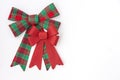 Large red and green plaid bow with smaller red holiday bow Royalty Free Stock Photo