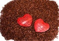 Large red heart sitting on top of scatterred coffee beans Royalty Free Stock Photo