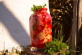 Large red jar with assorted pickles: red beets, cauliflower, cabbage, green tomatoes. Pickle jar with vegetables in red