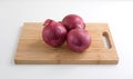 Large red onions on cutting board and counter top Royalty Free Stock Photo